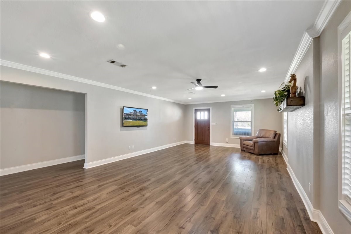 12335 2nd Street Santa Fe, TX 77539 - Photo 12 of 49 an empty room with wooden floor and windows