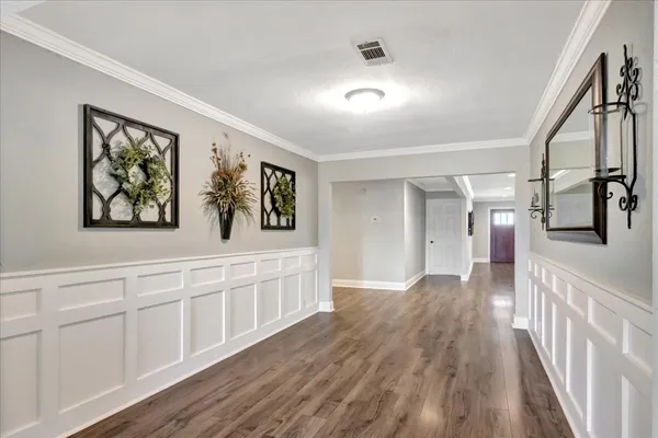 a view of a hallway with wooden floor