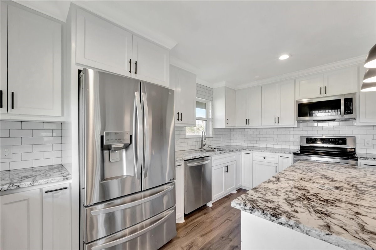 12335 2nd Street Santa Fe, TX 77539 - Photo 17 of 49 a kitchen with granite countertop a refrigerator stove and sink