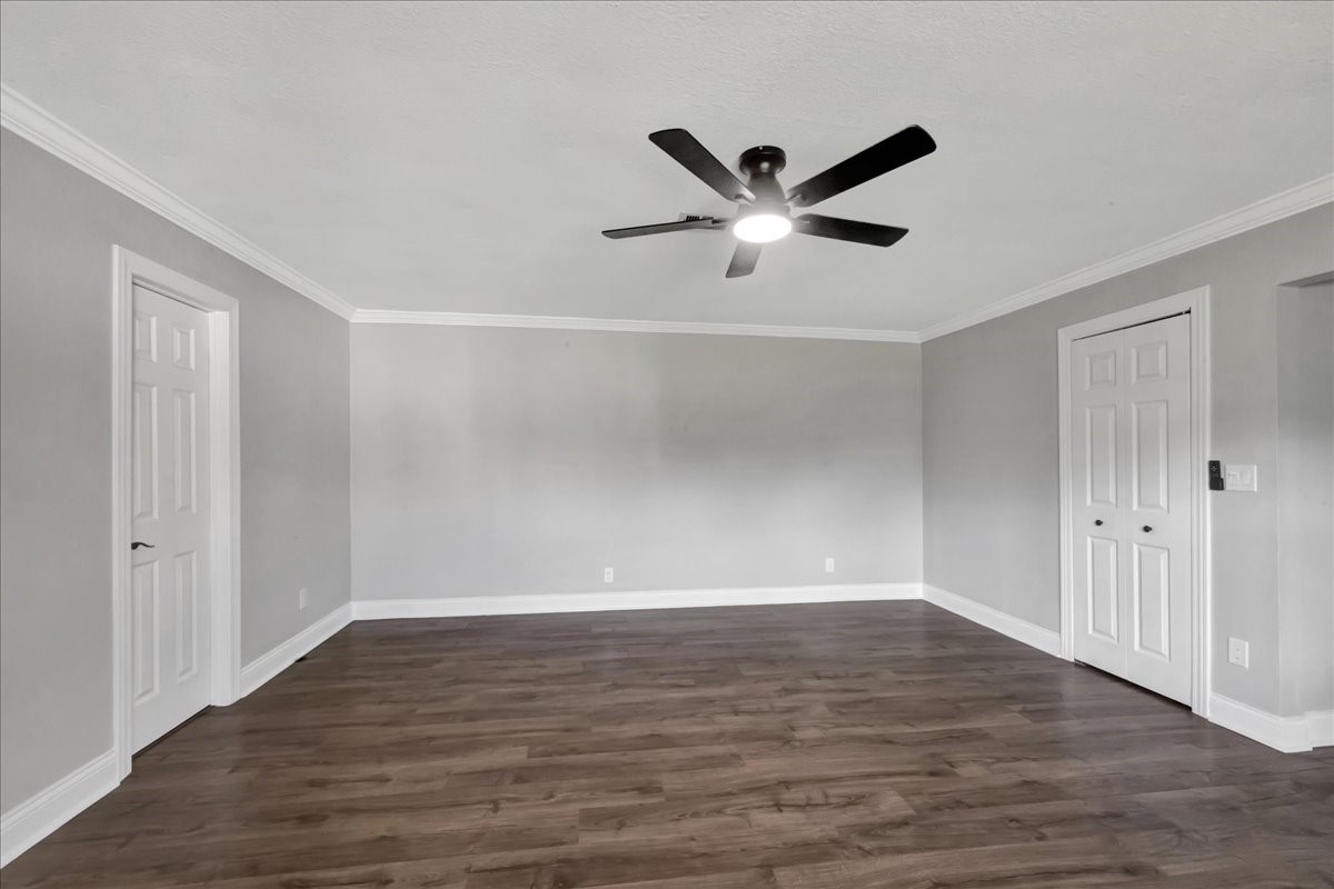 12335 2nd Street Santa Fe, TX 77539 - Photo 23 of 49 a view of an empty room with wooden floor and a ceiling fan