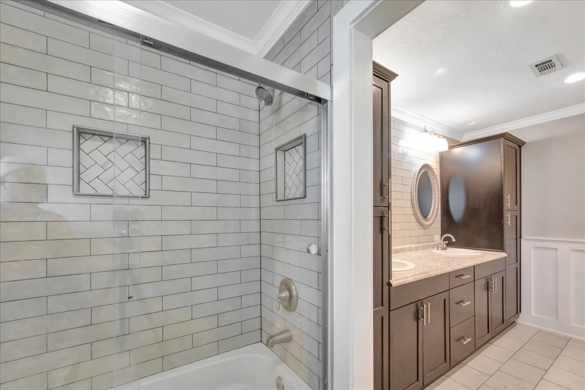 12335 2nd Street Santa Fe, TX 77539 - Photo 26 of 49 a bathroom with a double vanity sink and a mirror