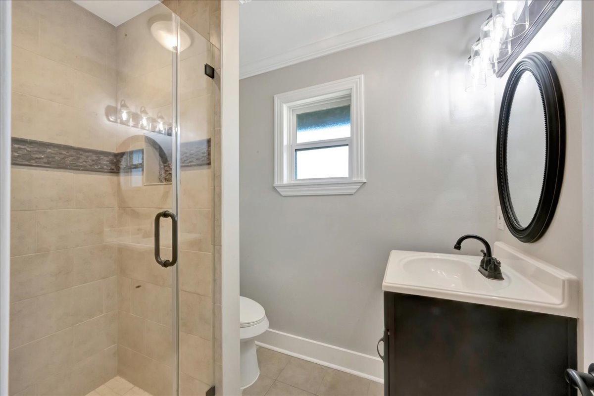 12335 2nd Street Santa Fe, TX 77539 - Photo 32 of 49 a bathroom with a sink a toilet and shower