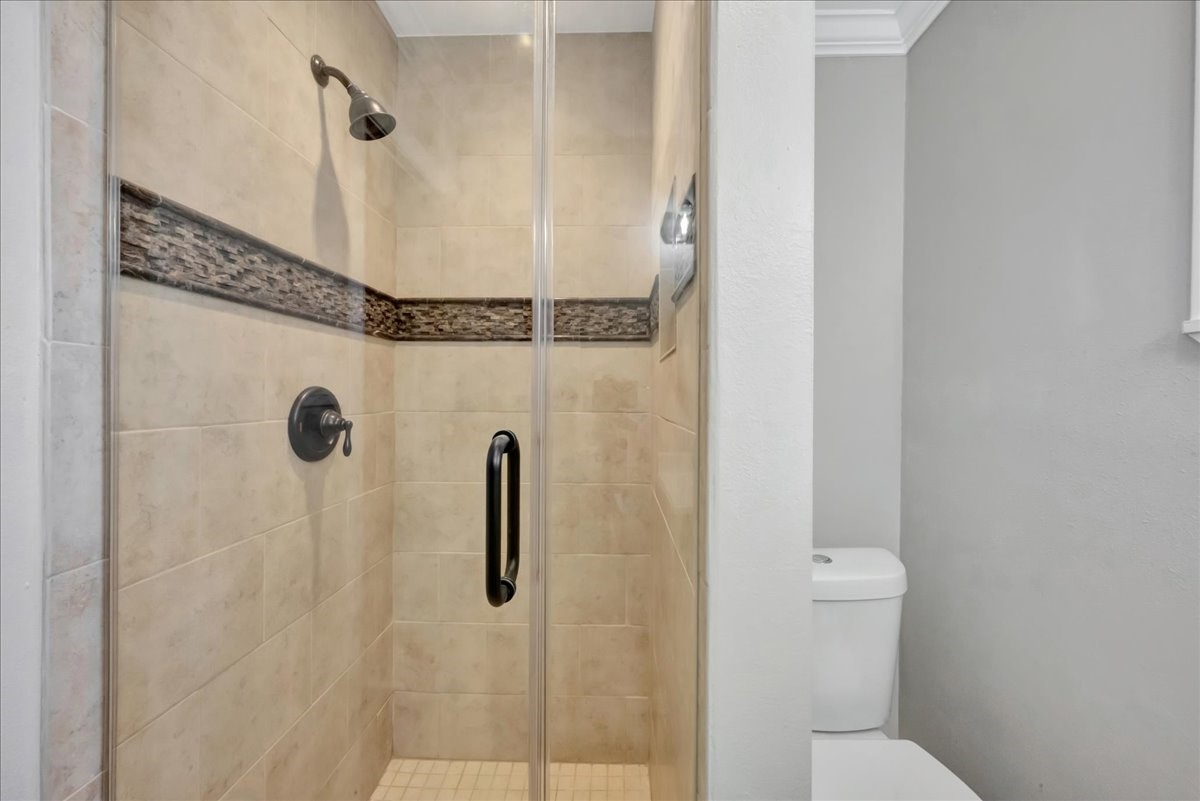 12335 2nd Street Santa Fe, TX 77539 - Photo 33 of 49 a bathroom with a shower and toilet