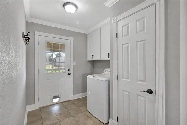 a view of a kitchen with white cabinets and refrigerator