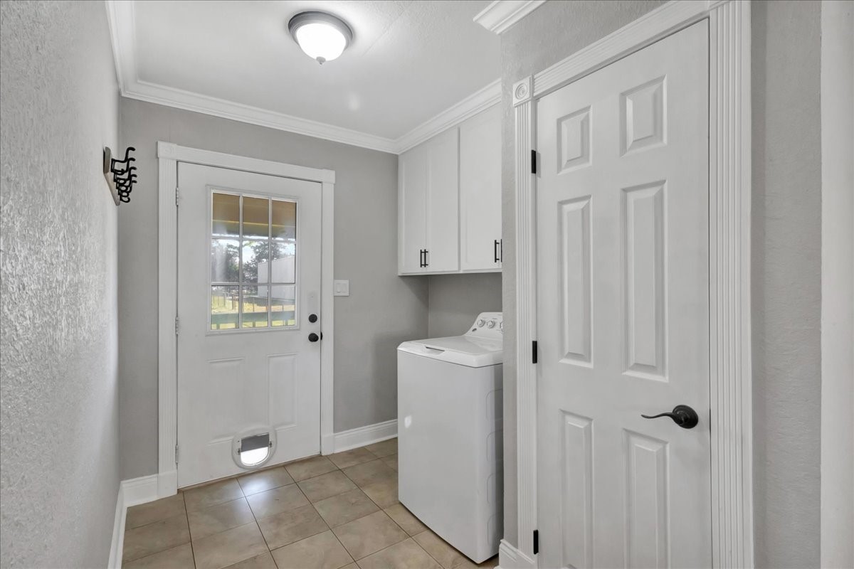 12335 2nd Street Santa Fe, TX 77539 - Photo 34 of 49 a view of a kitchen with white cabinets and refrigerator