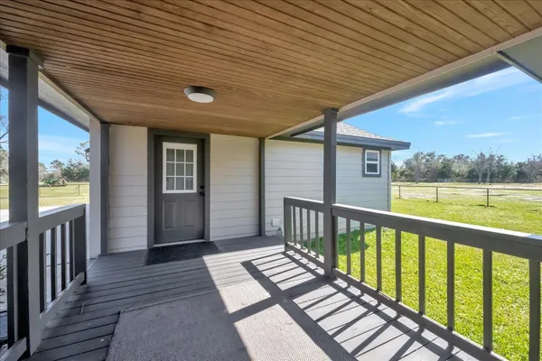 a view of a porch with wooden floor