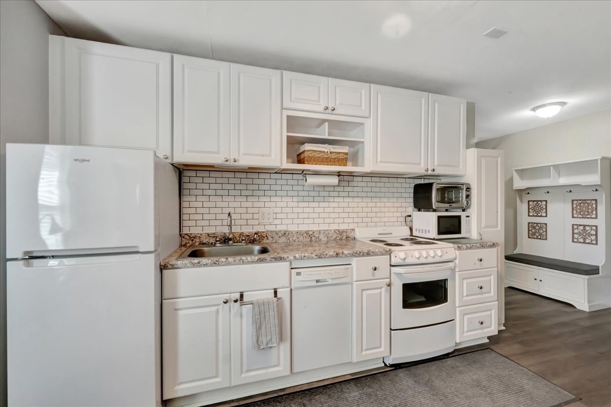 12335 2nd Street Santa Fe, TX 77539 - Photo 38 of 49 a kitchen with appliances a sink and cabinets