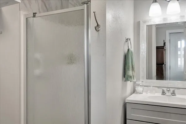 a bathroom with a shower and a mirror
