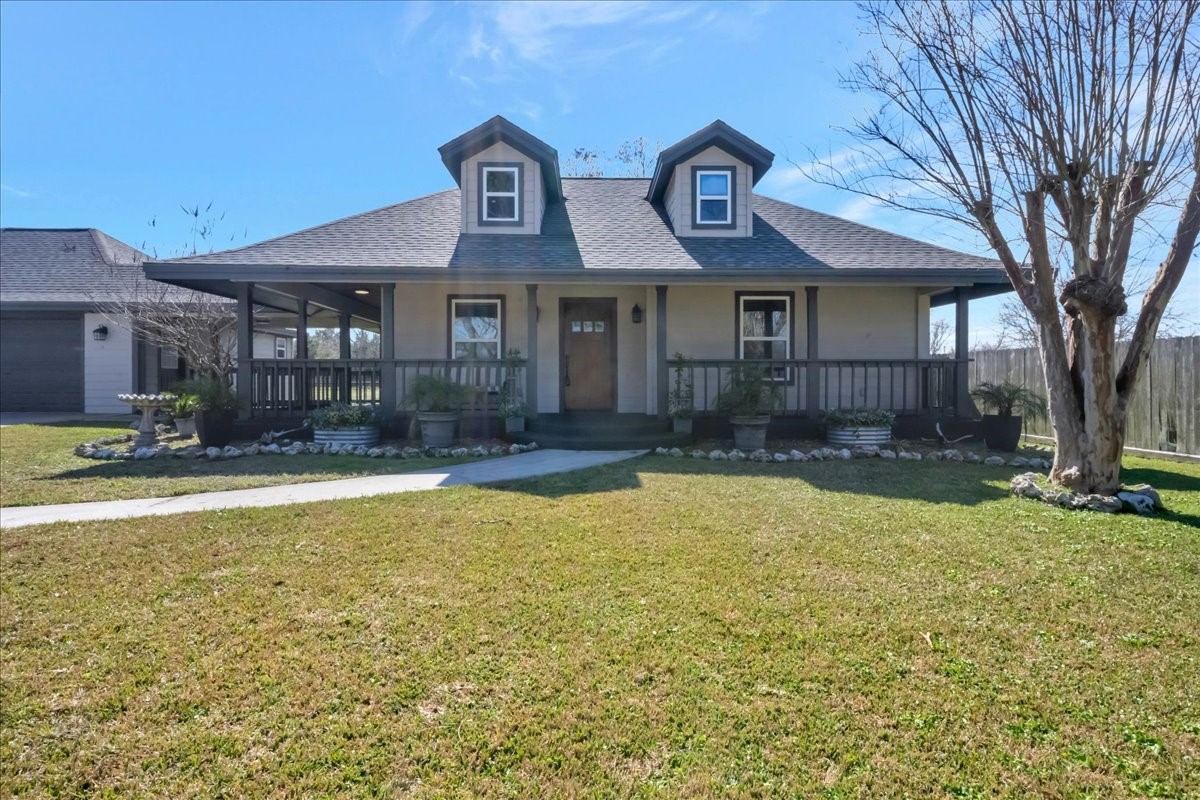 12335 2nd Street Santa Fe, TX 77539 - Photo 6 of 49 a front view of a house with swimming pool and a yard