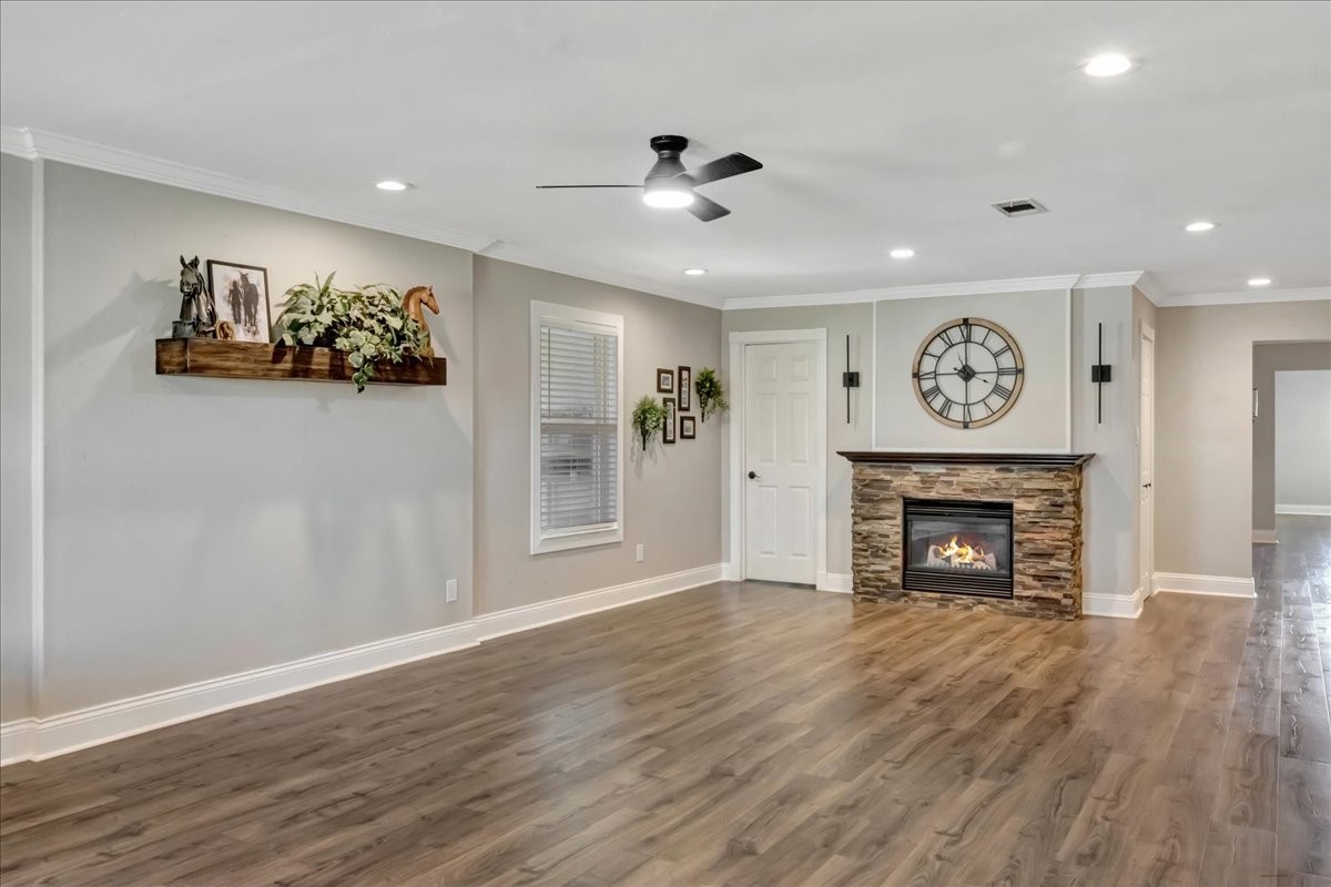 12335 2nd Street Santa Fe, TX 77539 - Photo 9 of 49 a view of an empty room with wooden floor a fireplace and a window