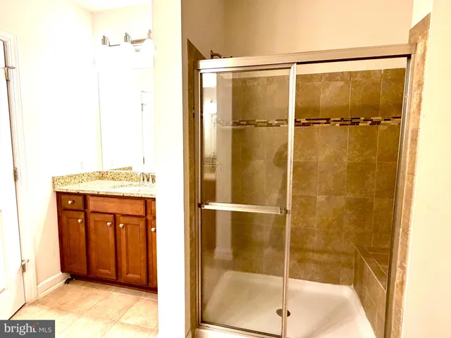 a bathroom with a shower and a sink