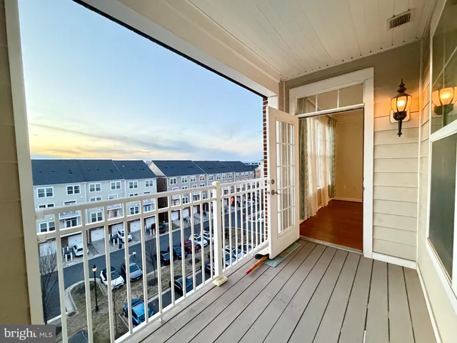 a view of a balcony with wooden floor