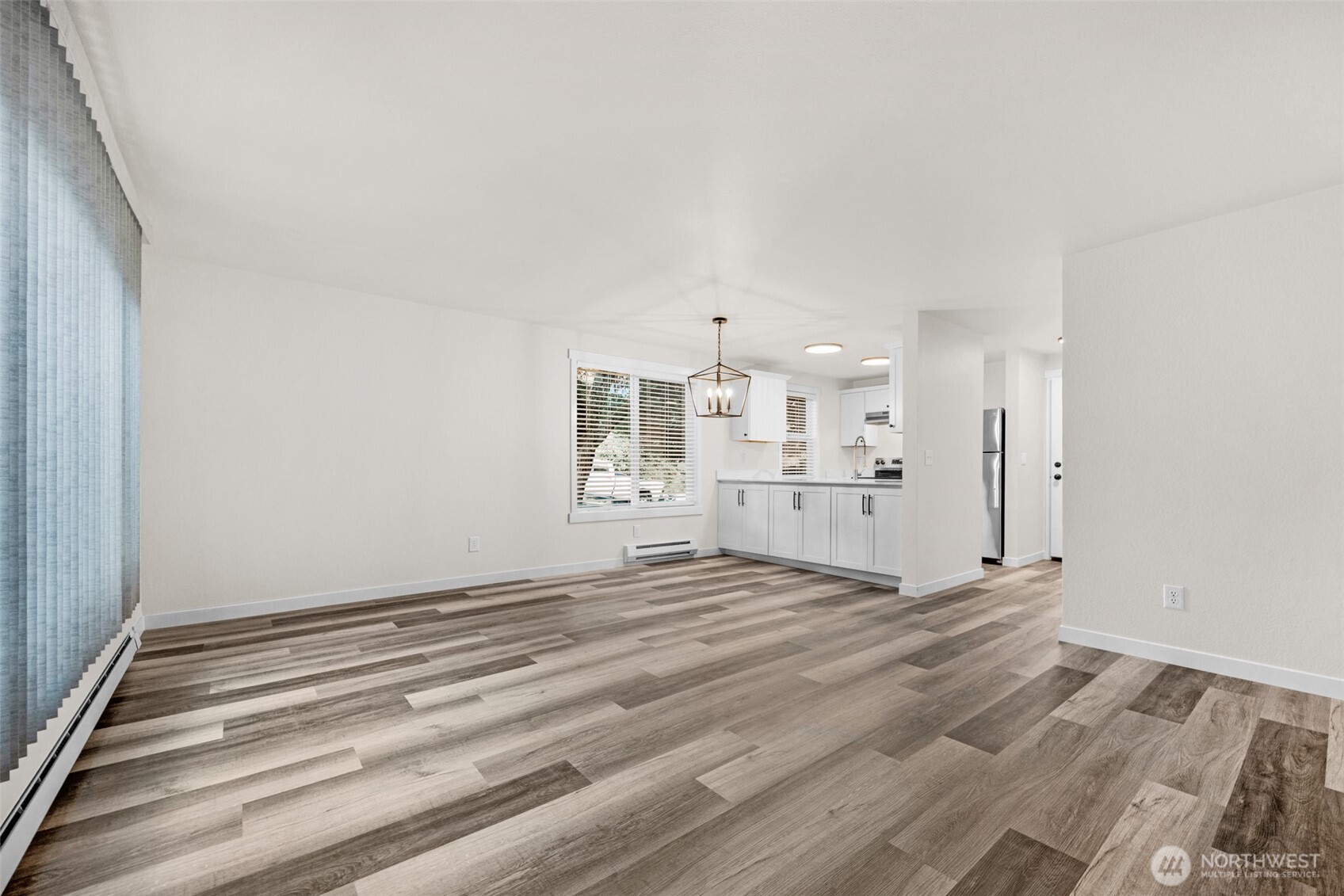 1302 Chestnut Street, Unit 2 Everett, WA 98201 - Photo 9 of 31 a view of kitchen and empty room with wooden floor