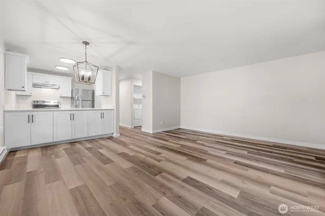 a view of a kitchen with granite countertop cabinets and wooden floor