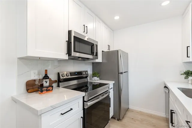 a kitchen with stainless steel appliances a stove microwave and refrigerator