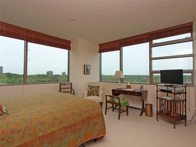 a living room with chairs and a flat screen tv