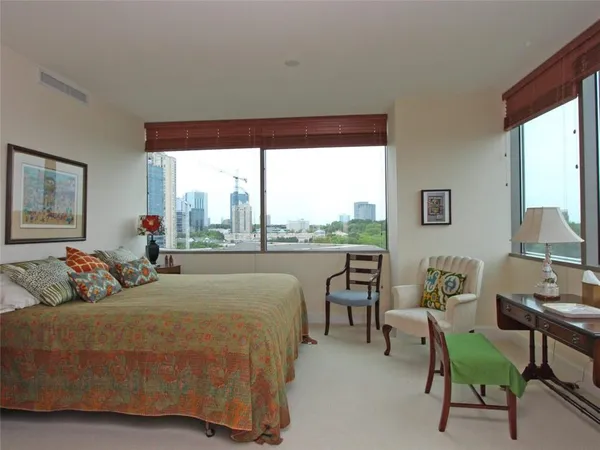 a bedroom with bed and a large window
