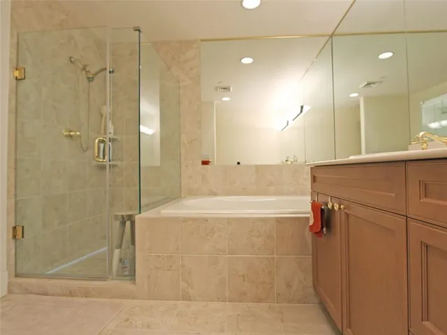 a bathroom with a shower and a mirror