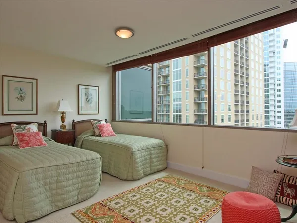 a bedroom with a bed and a large window