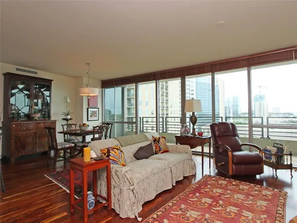 a living room with furniture and floor to ceiling windows