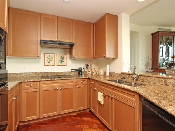 a kitchen with stainless steel appliances granite countertop a sink stove and cabinets