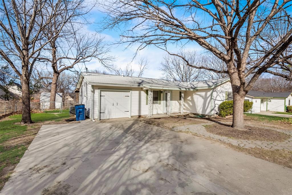 a view of a house with a yard and trees