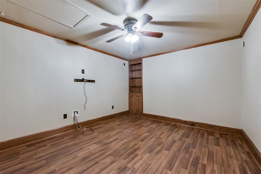 336 Shoreline Drive Azle, TX 76020 - Photo 17 of 20 a view of an empty room with wooden floor and a ceiling fan