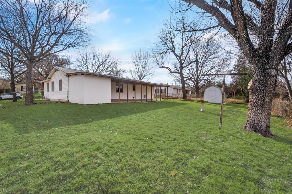 336 Shoreline Drive Azle, TX 76020 - Photo 20 of 20 a view of a house with backyard and a tree