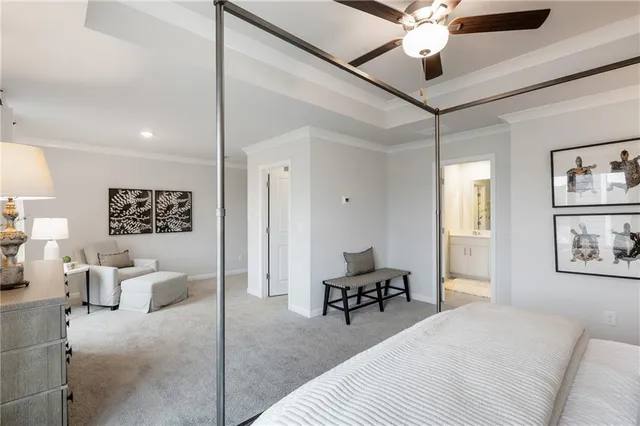 a bedroom with a bed furniture and a ceiling fan