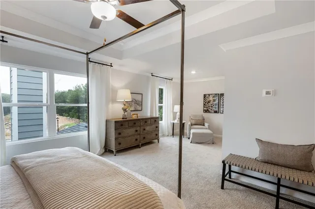 a large bedroom with a bed window and couch