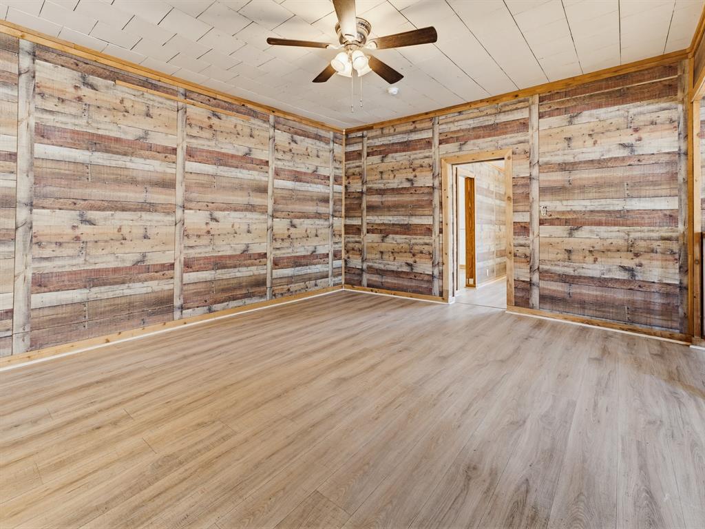601 South Miller Street Decatur, TX 76234 - Photo 11 of 36 en empty room with wooden floor and windows