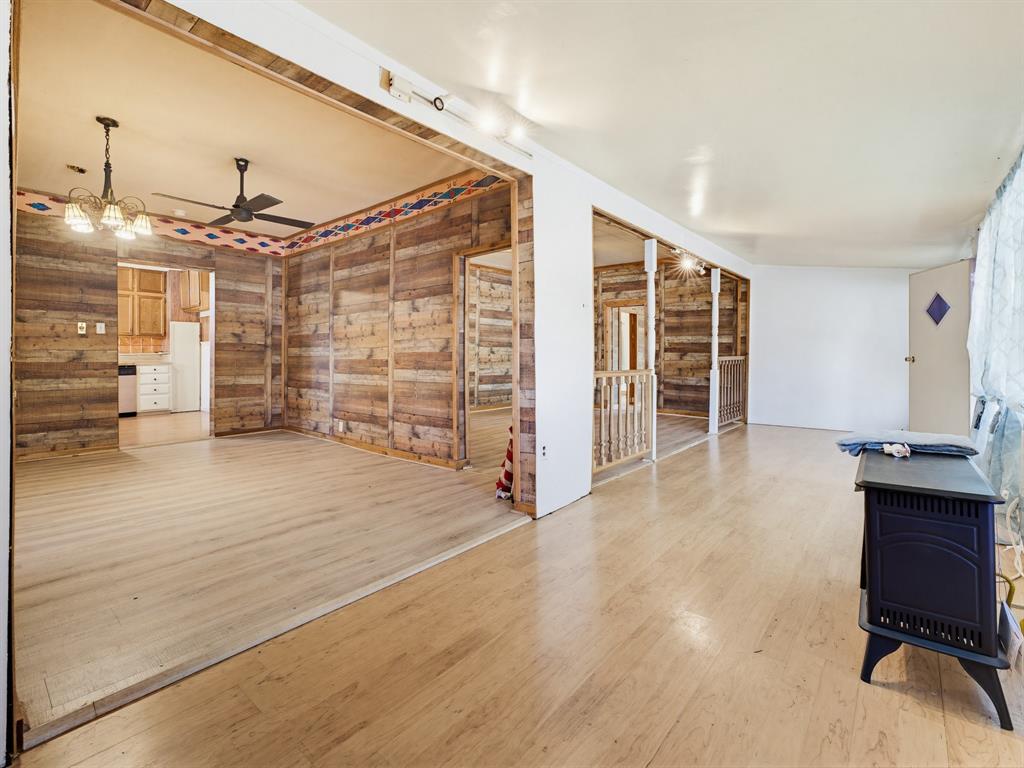 601 South Miller Street Decatur, TX 76234 - Photo 6 of 36 an empty room with wooden floor and windows