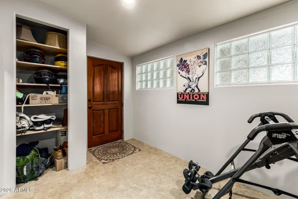 a living room with furniture a dining table and paintings on the wall
