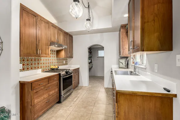 a view of a patio with a table and chairs and potted plants