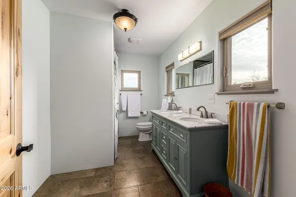 an aerial view of a house with a yard and lake view