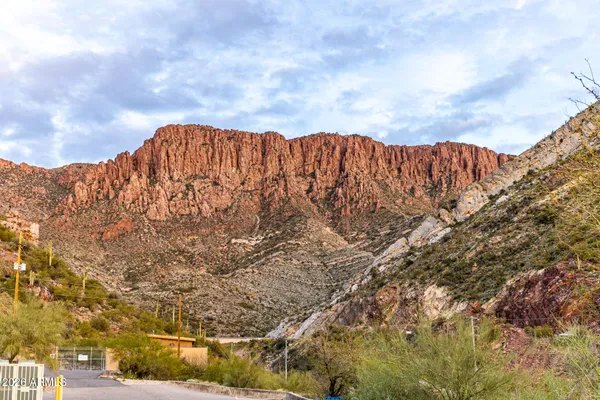 a spacious bedroom with a bed and a chandelier
