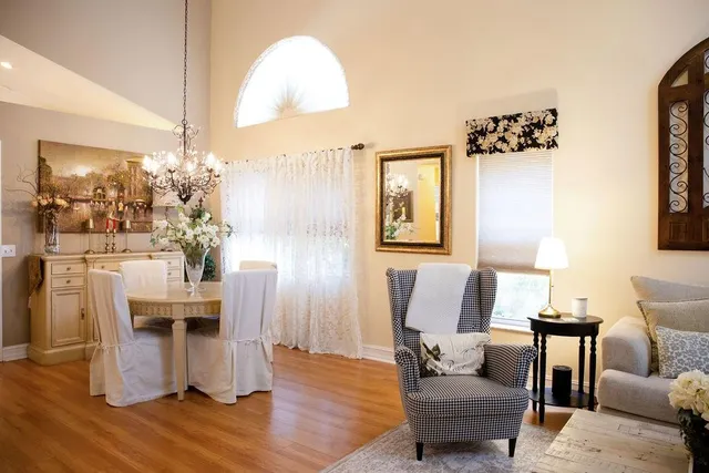 a living room with furniture and a chandelier