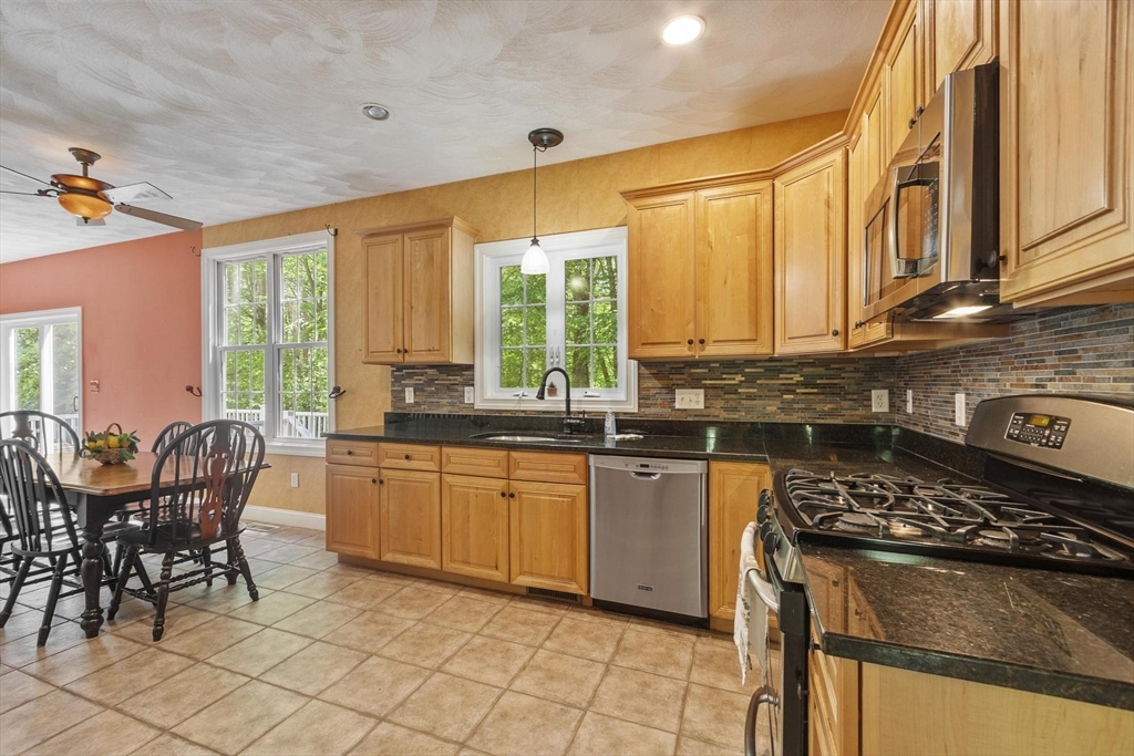 4 Forest Street Georgetown, MA 01833 - Photo 11 of 37 a kitchen with stainless steel appliances granite countertop a stove a sink and a microwave