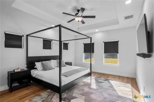 a bedroom with a bed and a flat screen tv