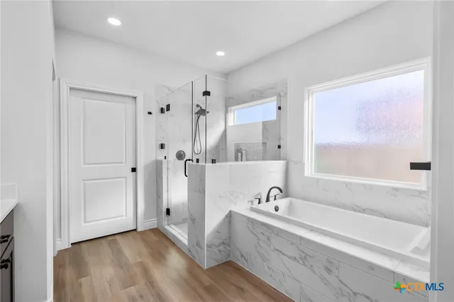 a spacious bathroom with a bathtub and a shower