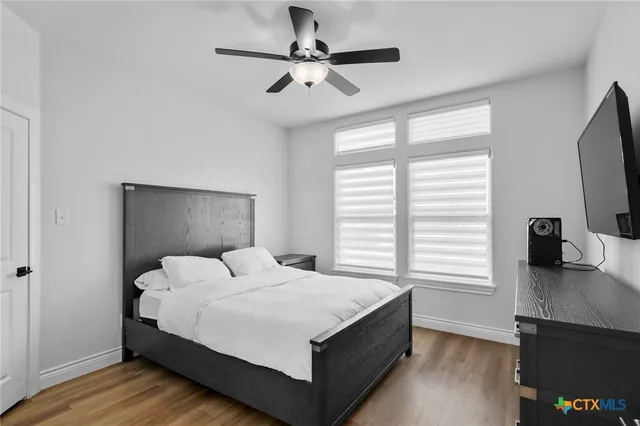 a bedroom with a bed and a flat screen tv
