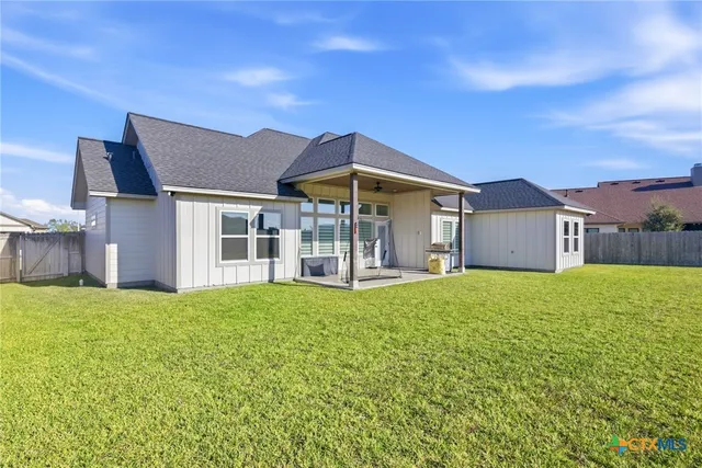 a view of a house with a yard and deck