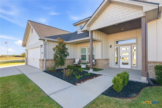 a front view of a house with garden