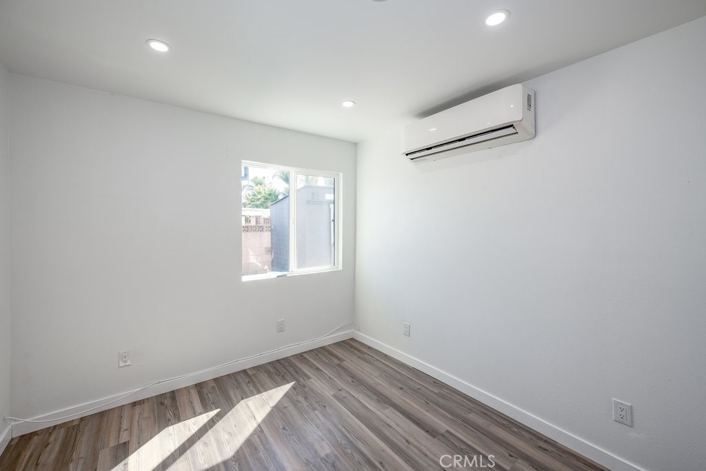 1069 Erringer Road, Unit 1 Simi Valley, CA 93065 - Photo 4 of 8 a view of empty room with wooden floor and fan