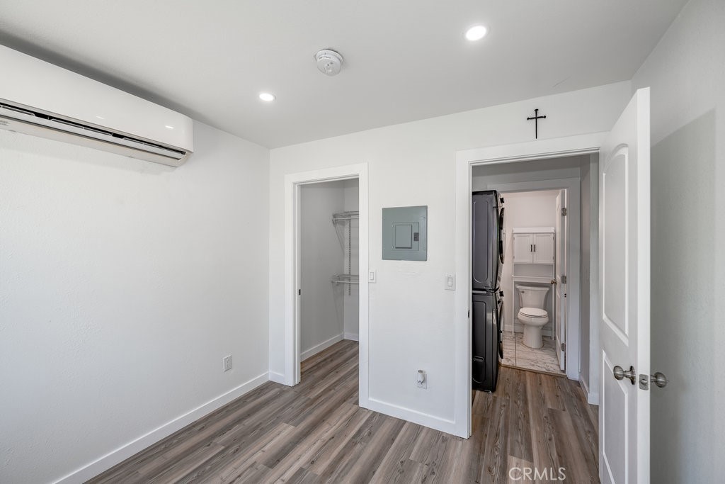 1069 Erringer Road, Unit 1 Simi Valley, CA 93065 - Photo 5 of 8 a view of a hallway with wooden floor and closet area