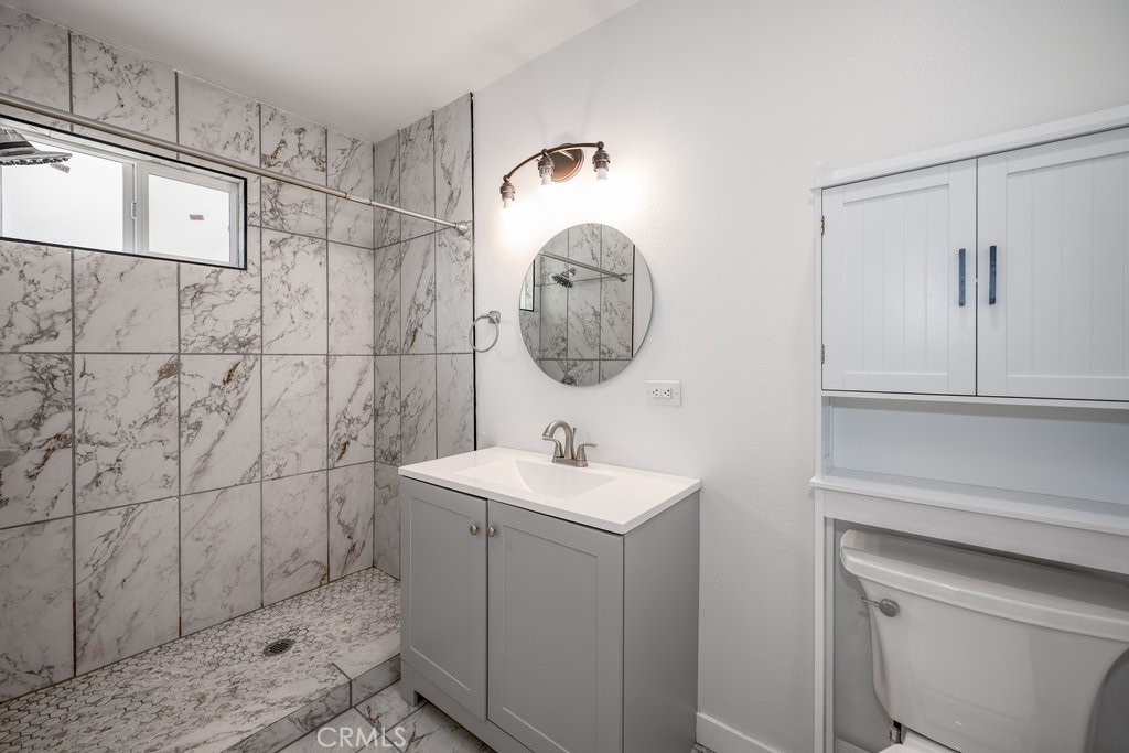 1069 Erringer Road, Unit 1 Simi Valley, CA 93065 - Photo 6 of 8 a bathroom with a sink a toilet and shower