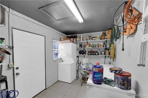 a view of a hallway with a white door and wooden floor