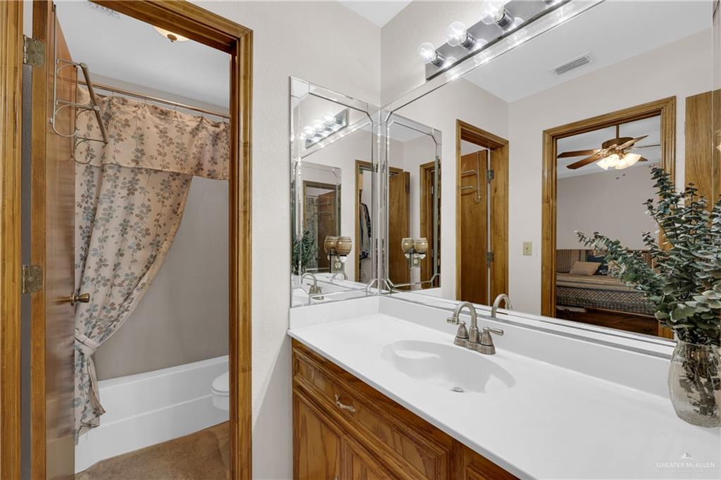 1607 West Main Street Rio Grande City, TX 78582 - Photo 27 of 31 a bathroom with a bathtub sink and mirror
