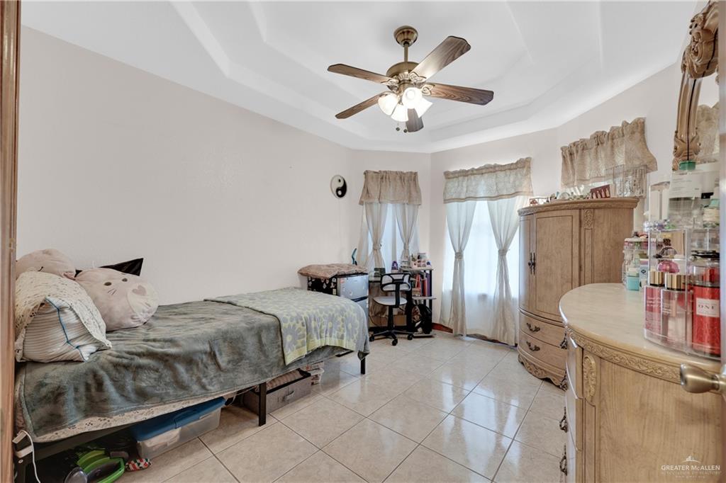 1607 West Main Street Rio Grande City, TX 78582 - Photo 28 of 31 a bedroom with bed and a chandelier