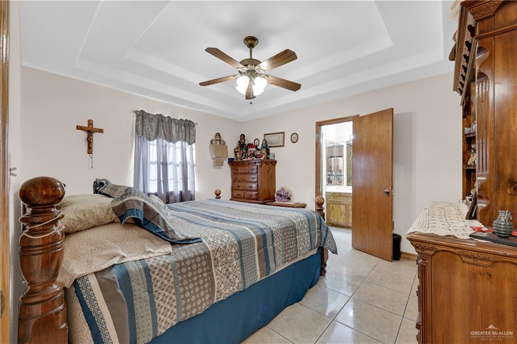 1607 West Main Street Rio Grande City, TX 78582 - Photo 30 of 31 a bedroom with a bed and ceiling fan